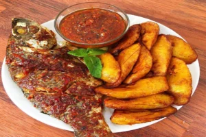 Grilled Fish with ripe plantain served on a white dish